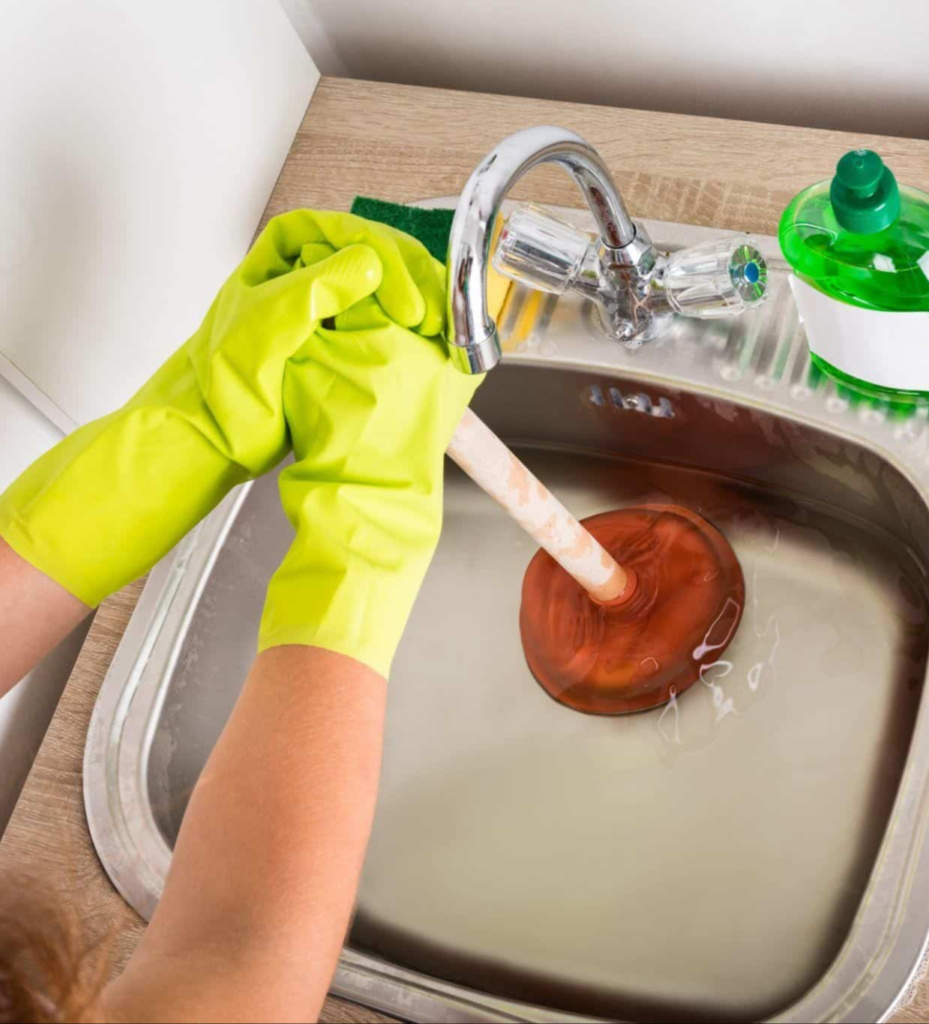 Woman Learning How To Unblock A Sink (1)